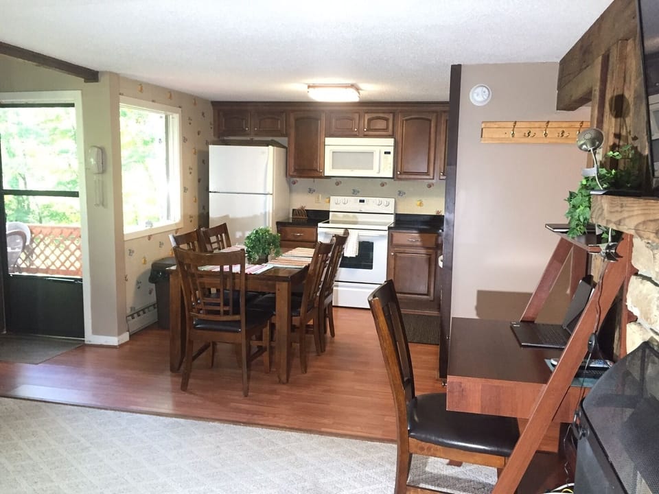 View from living room into kitchen.  Door goes to private deck.