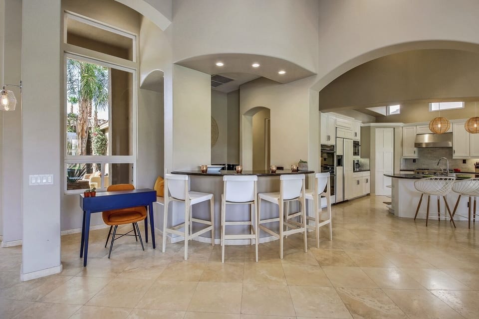 Conveniently located near the pool table is the built in wet bar with room for FOUR. It features a sink and mini-fridge. Small blue desk is perfect to get some work done while taking in the view