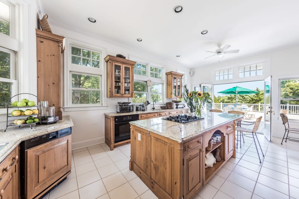 Well appointed eat-in gourmet kitchen which opens to deck with grill.