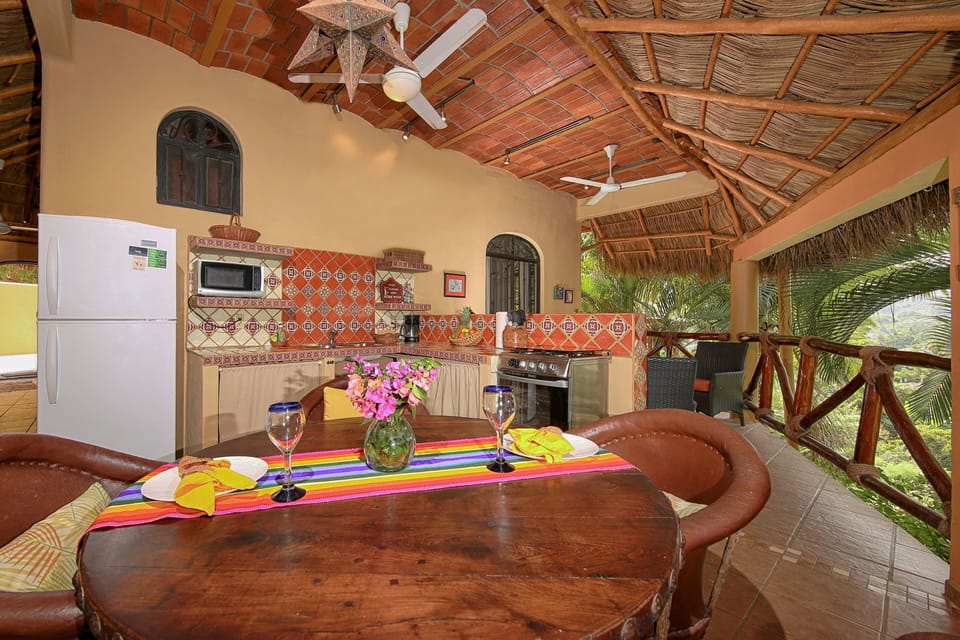 Unique indoor/outdoor living space all housed under a palapa roof.