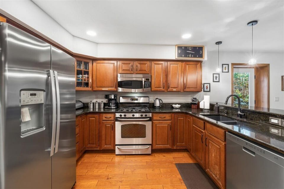 Fully stocked kitchen with large gas range, new refrigerator and dishwaser