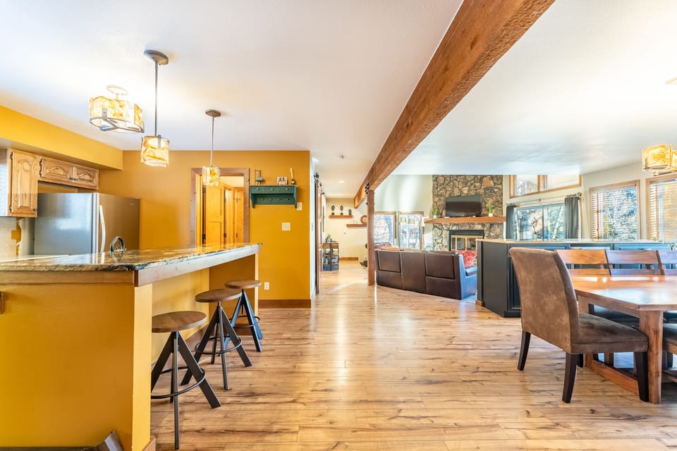 Your cozy retreat features warm colors, exposed beams, and an open layout connecting kitchen, dining, and living spaces perfectly.