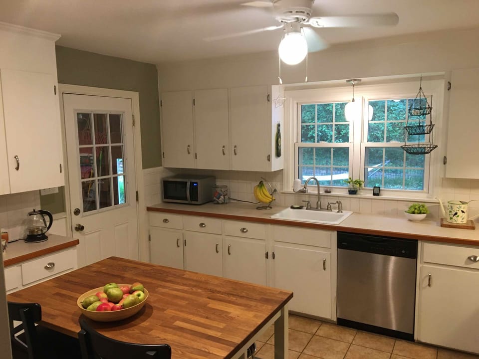 Kitchen includes a work island with two bar stools