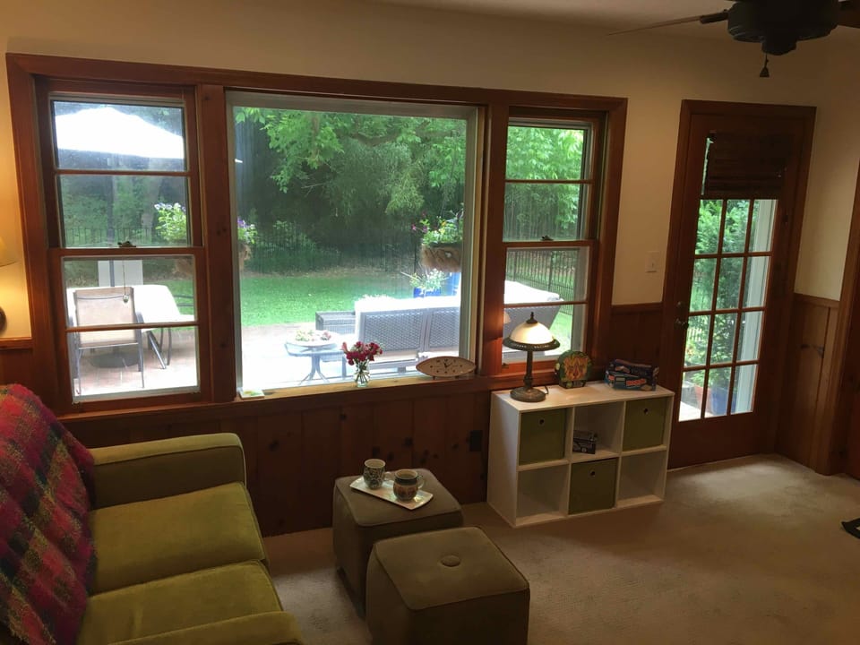 Den with view of backyard and patio