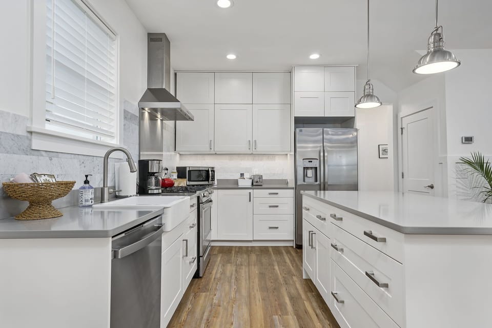 Modern Kitchen with Island seating, SS appliances and gas stove. 