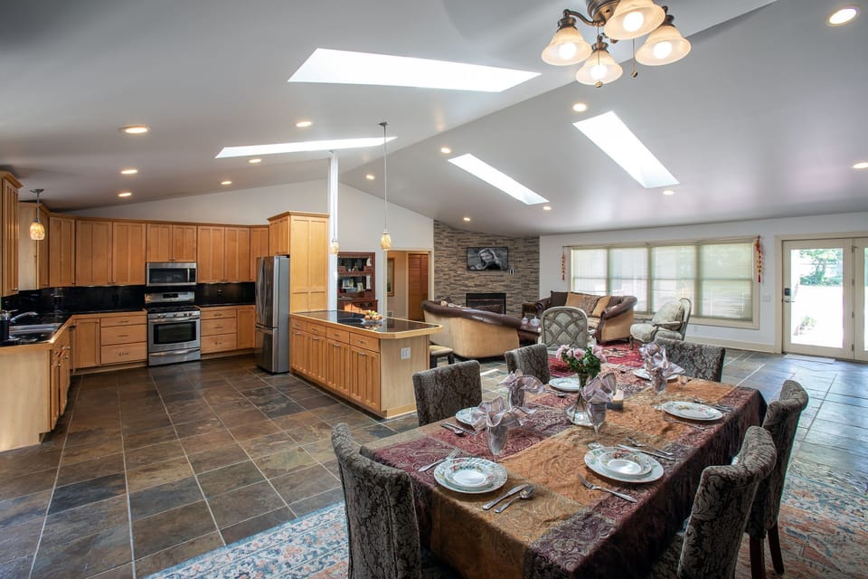 Dinning Room with view of Kitchen w Breakfast Counter, Living Room & front door.