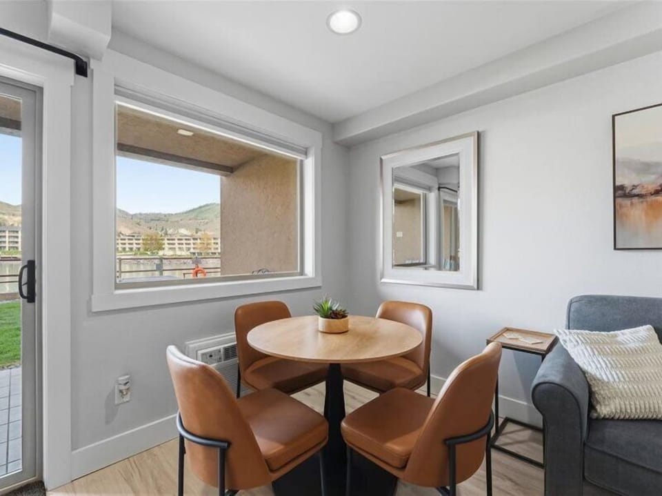 Gather around the round table with mountain views framing your morning coffee. The warm leather chairs and natural light create the perfect spot for shared meals and conversation.