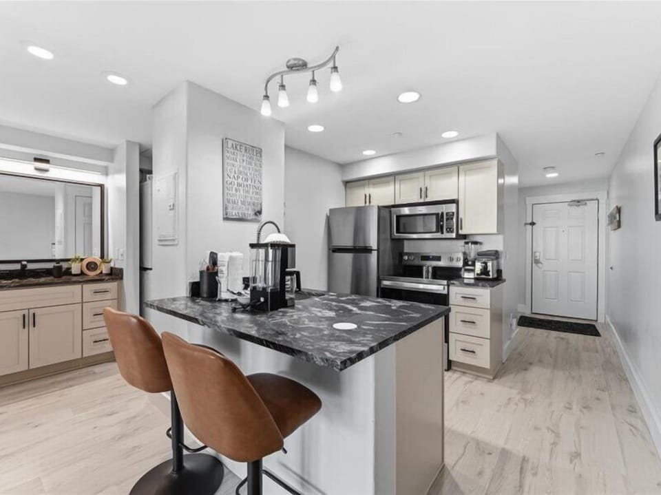 Step into your well-appointed kitchen with stunning granite countertops, stainless steel appliances, and stylish island seating—perfect for morning coffee or preparing your favorite meals.