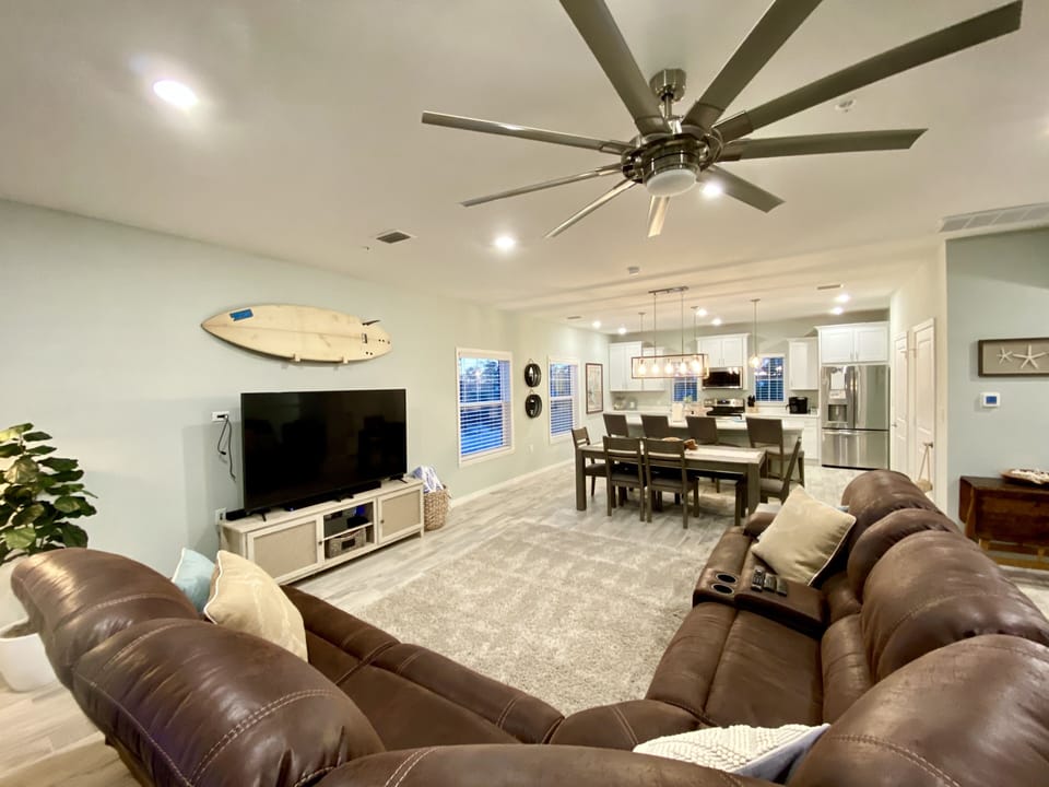 Living Room with electric reclining sofa, Smart TV and XBox gaming system.