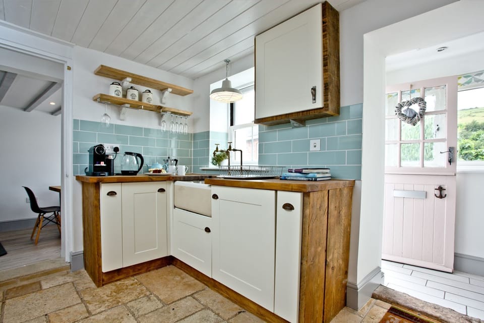 Kitchen with coffee machine, kettle, and Belfast sink - Birdcage Cottage