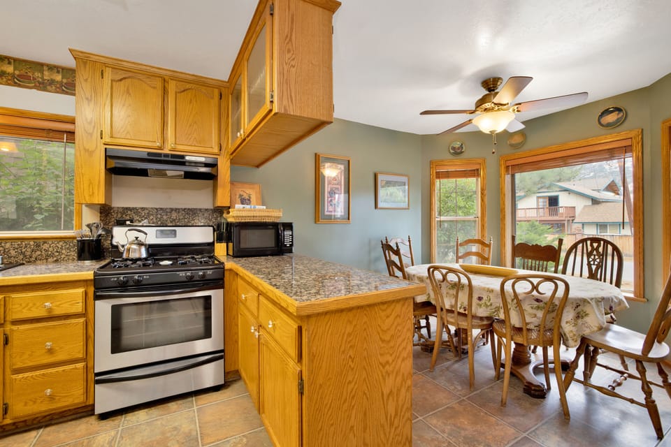 Fully equipped cabin kitchen with ample cabinetry, stove, fridge, microwave, and coffee maker—perfect for cooking meals, morning coffee, and feeling right at home on your stay.