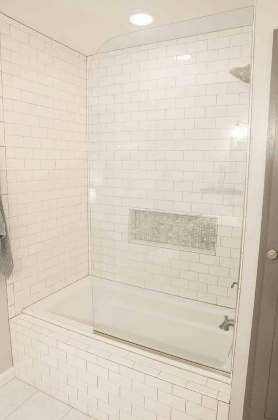 Large updated master bathroom tiled shower tub, updated vanity, and linen closet