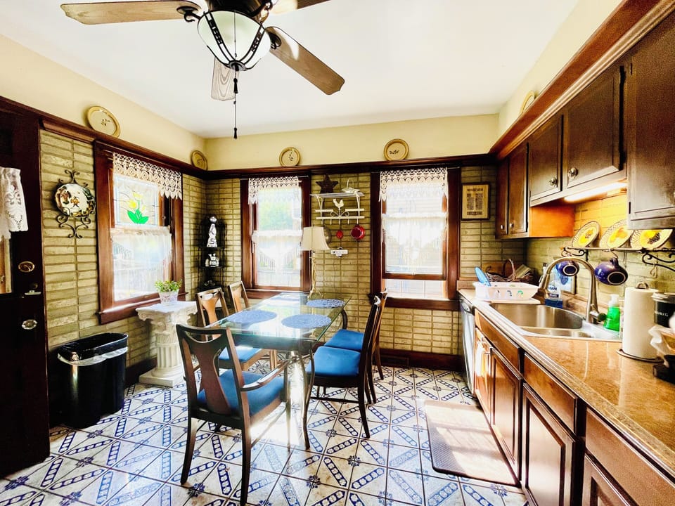 Large sunny tile kitchen with stainless sink, dishwasher, double door fridge