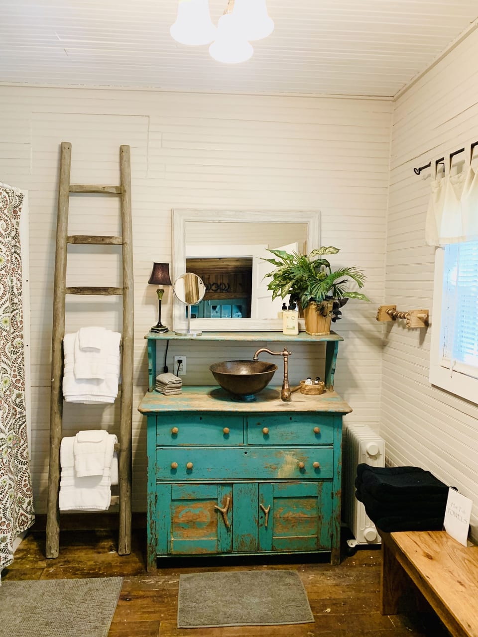 Bright, clean main bathroom with antique furnishings