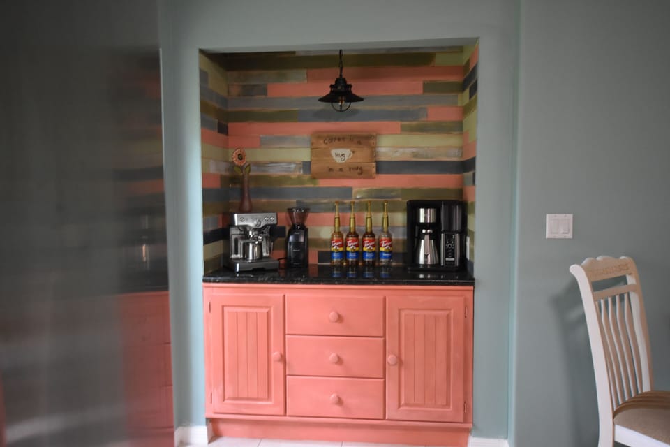 Coffee bar with an espresso machine, drip coffee maker, and bean grinder