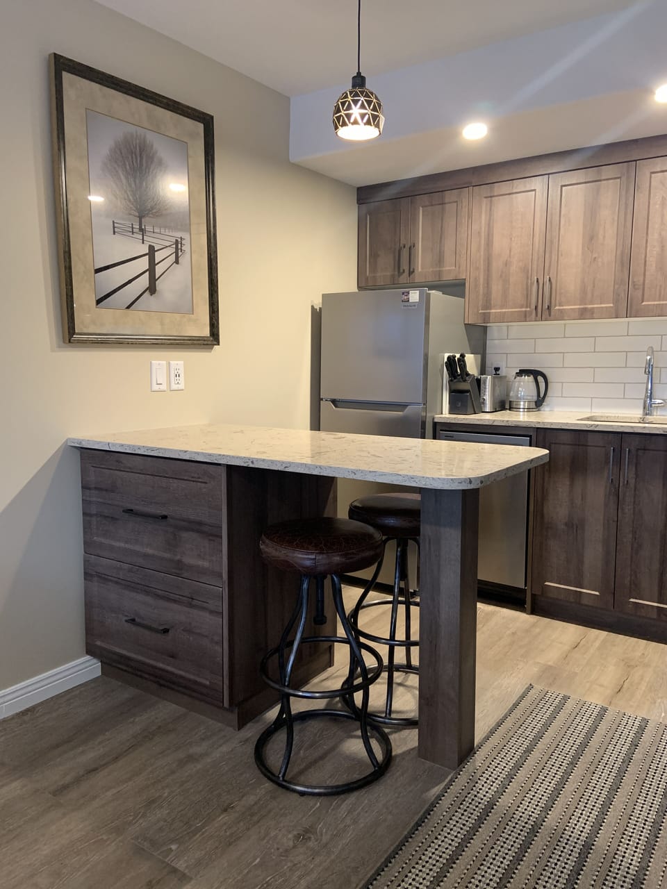 Full suite size kitchen with table for eating or working and large storage draws