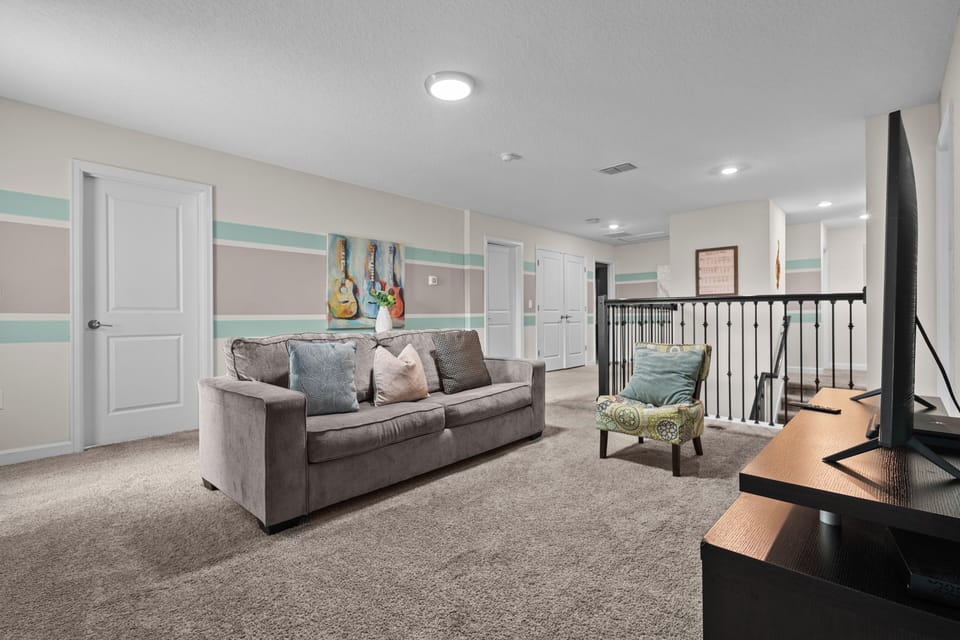 Unwind in your spacious upstairs living area with plush seating and cheerful décor—perfect for relaxing after exploring.