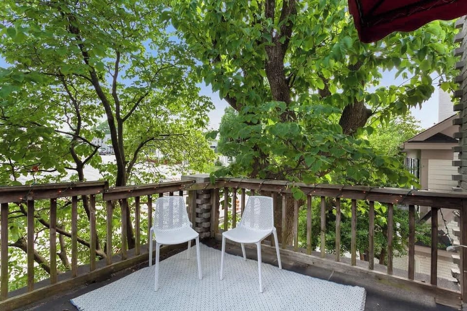 Our home's private balcony with string lights & patio seating, covered by gorgeous old trees - balcony overlooks downtown Fayetteville as our place is on the second floor.