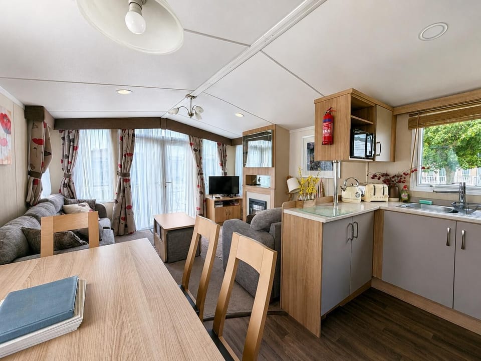 Unwind on the plush seating as the gas fireplace warms the room, creating the perfect atmosphere for a relaxing evening after a day out in Great Yarmouth.
