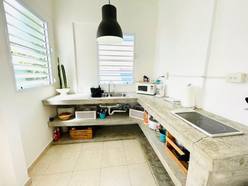 Make your own meals in this large industrial type kitchen after a long day at the beach.