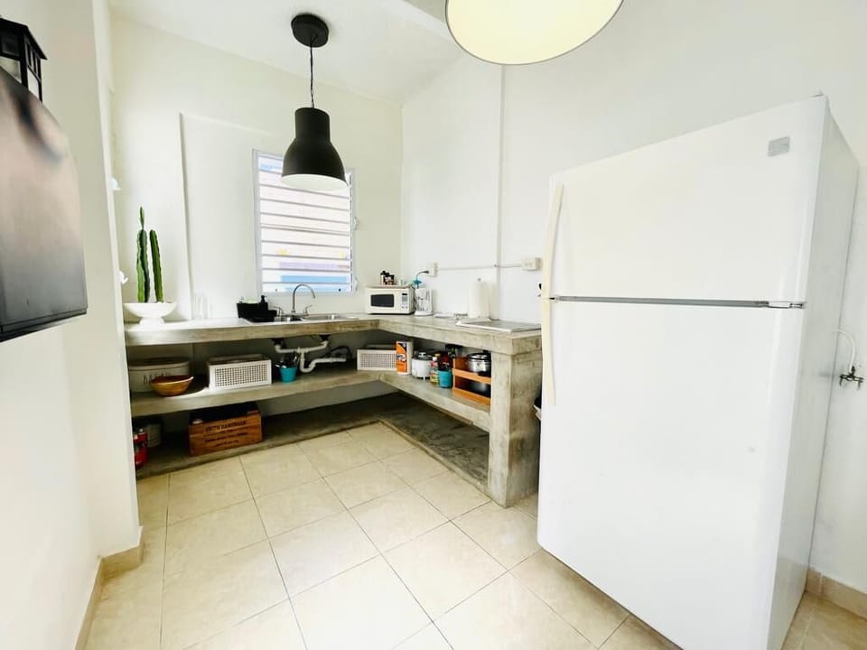 Large concrete cement kitchen so you can cook your own meals. It has a stove, fridge, microwave, coffee maker, toaster, etc. 