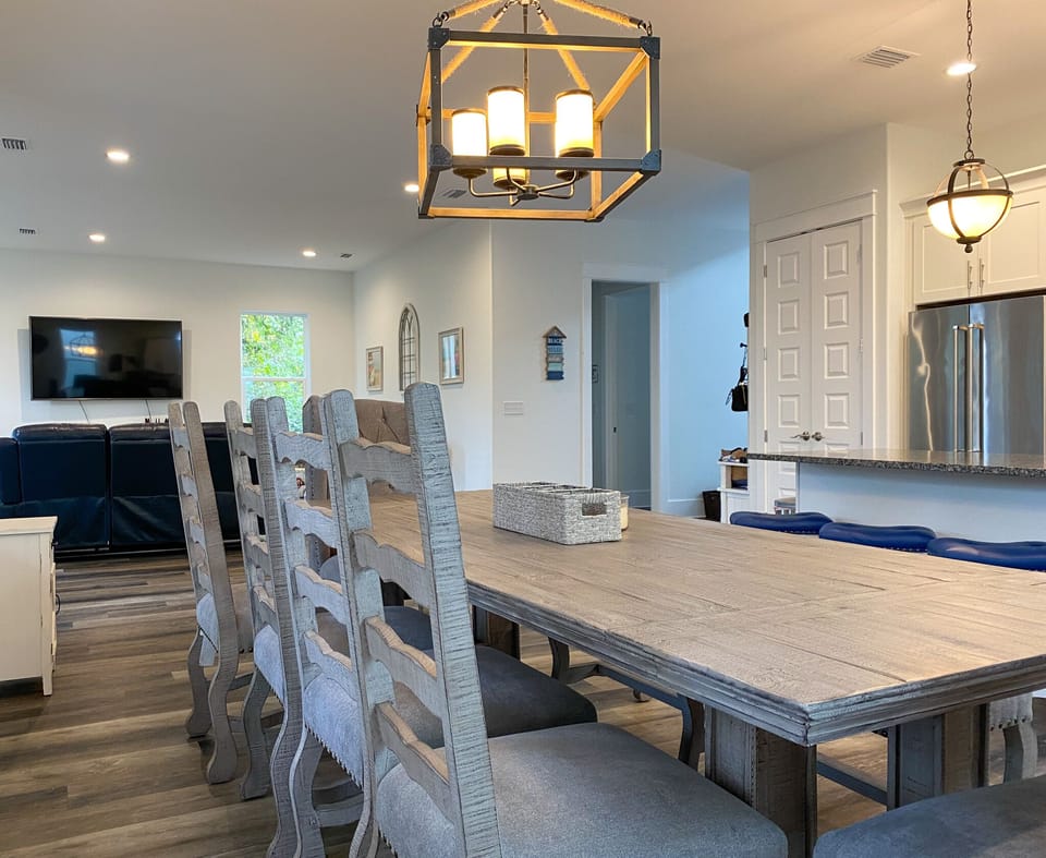 Large table seating of 9 with view of 75" Tv.