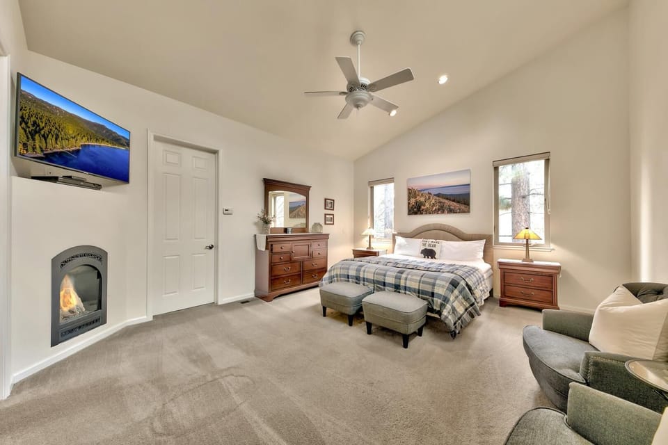 Unwind in your spacious bedroom where warm fireplace flames dance as you watch TV from the plush armchair or cozy bed.