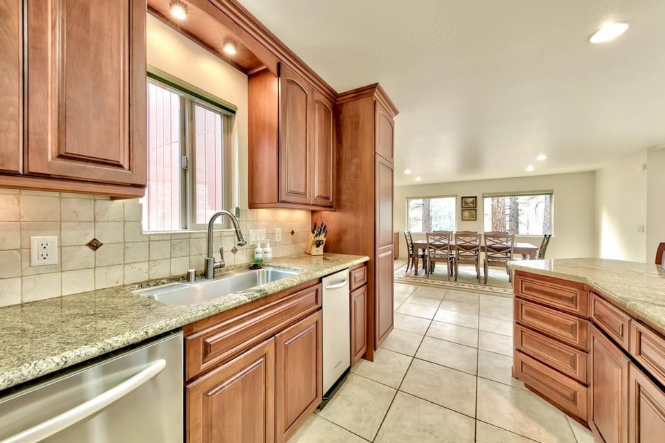 Your gourmet kitchen awaits with warm wood cabinetry, granite counters, and modern appliances—perfect for creating memorable meals during your stay.