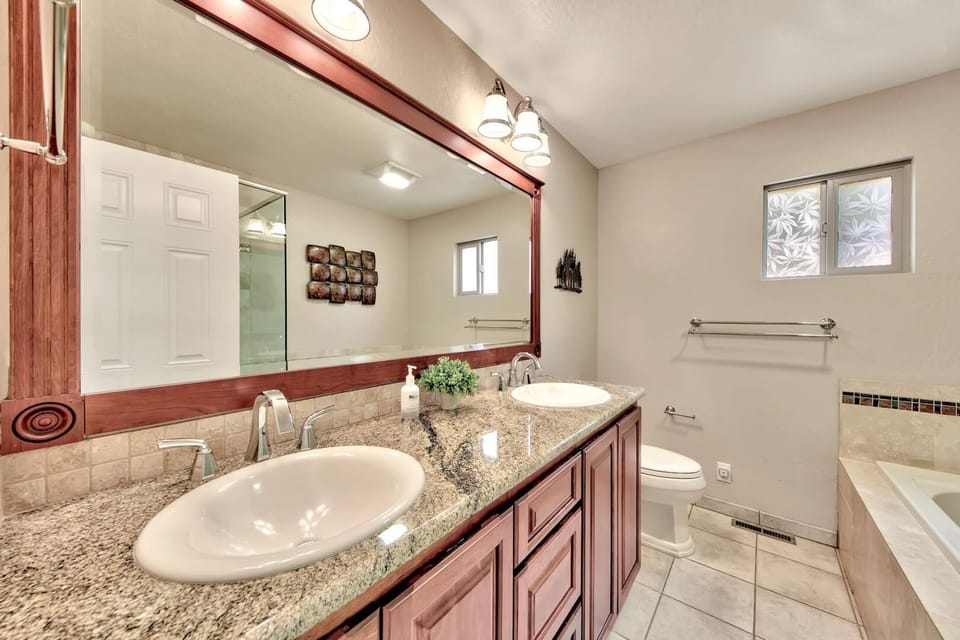 Relax in your elegant bathroom featuring dual vanities, granite countertops, and a spacious tub perfect for unwinding after your adventures.
