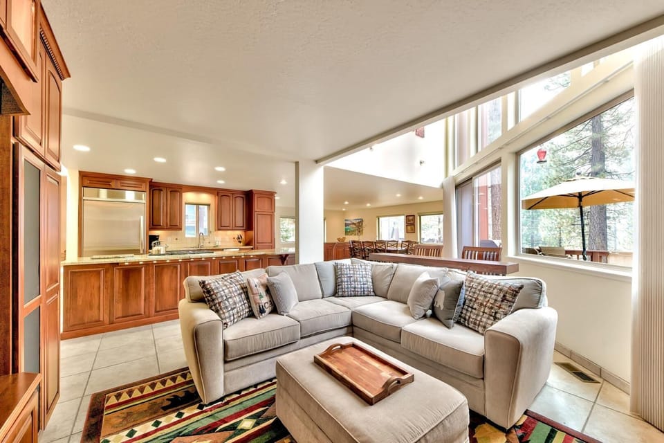 Unwind in your spacious living room with plush sectional seating and stunning views through floor-to-ceiling windows that fill the space with natural light.