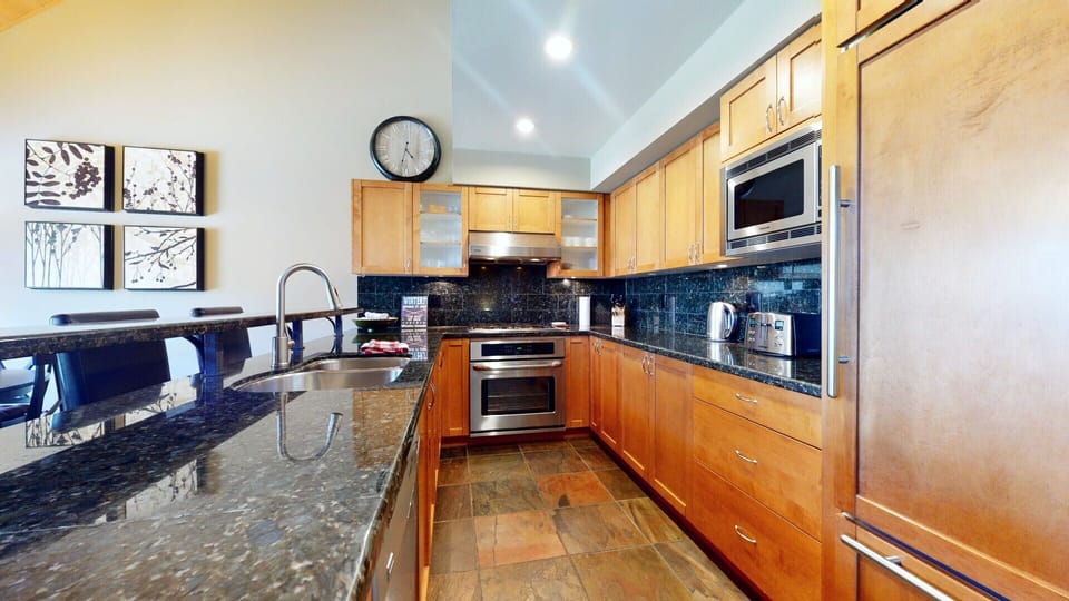 Open-concept kitchen with a breakfast bar for casual dining and conversation.