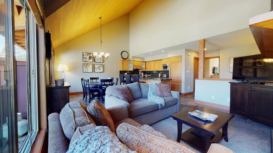 Relax by the gas fireplace in a spacious, open-concept living area.