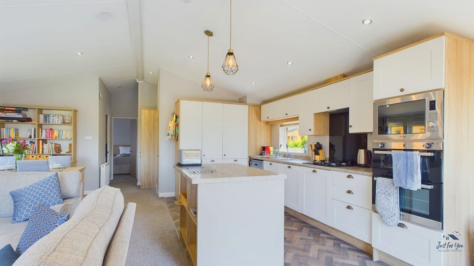 Close-up of kitchen appliances at Poppy Lodge, including fridge, oven and coffee maker — perfect for self-catering stays.