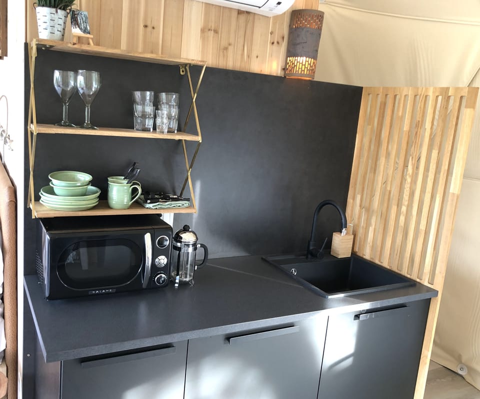 Kitchenette has a sink, small fridge and microwave.  