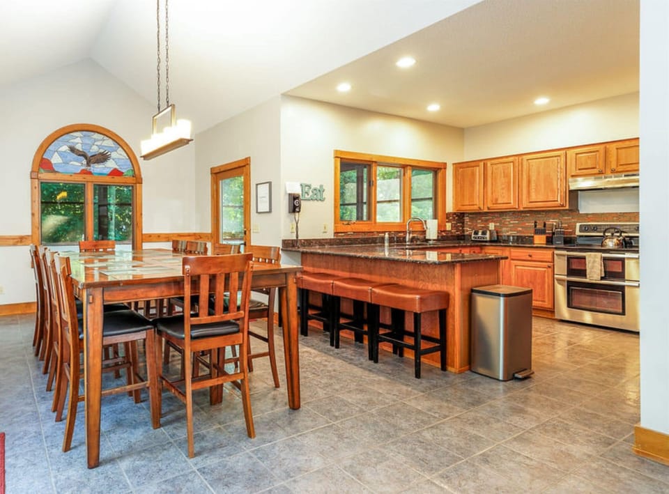 Dining room table seats up to 10 with 4 additional stools at breakfast bar