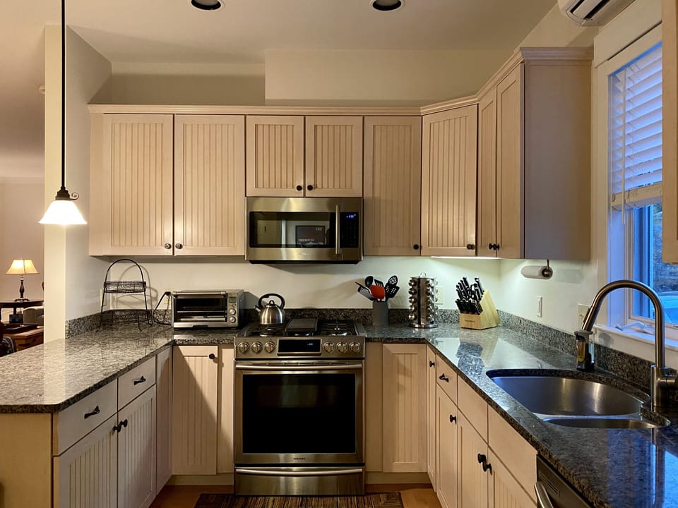 Newly renovated kitchen stocked with cookware and dishes
