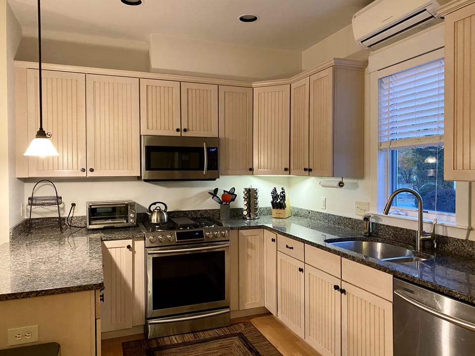 Newly renovated kitchen stocked with cookware and dishes