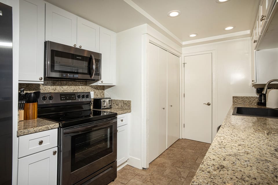 The chef's kitchen has granite counters and stainless steel appliances. Washer & Dryer.