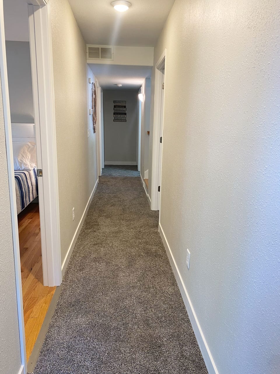 The hallway leads to the 4 bedrooms and one hallway bathroom, plus laundry. 