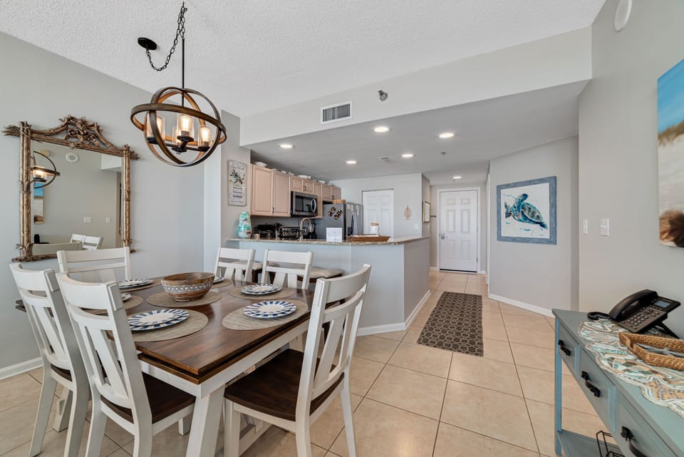 Flexible dining options for every occasion. Enjoy a formal meal at the dining table or a casual snack at the breakfast bar, seamlessly connected to the fully equipped kitchen.