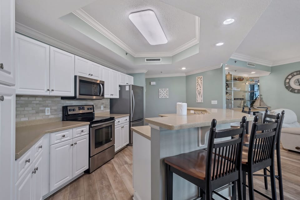 he perfect spot for morning coffee or evening cocktails, this kitchen and breakfast bar is ready for you to enjoy.