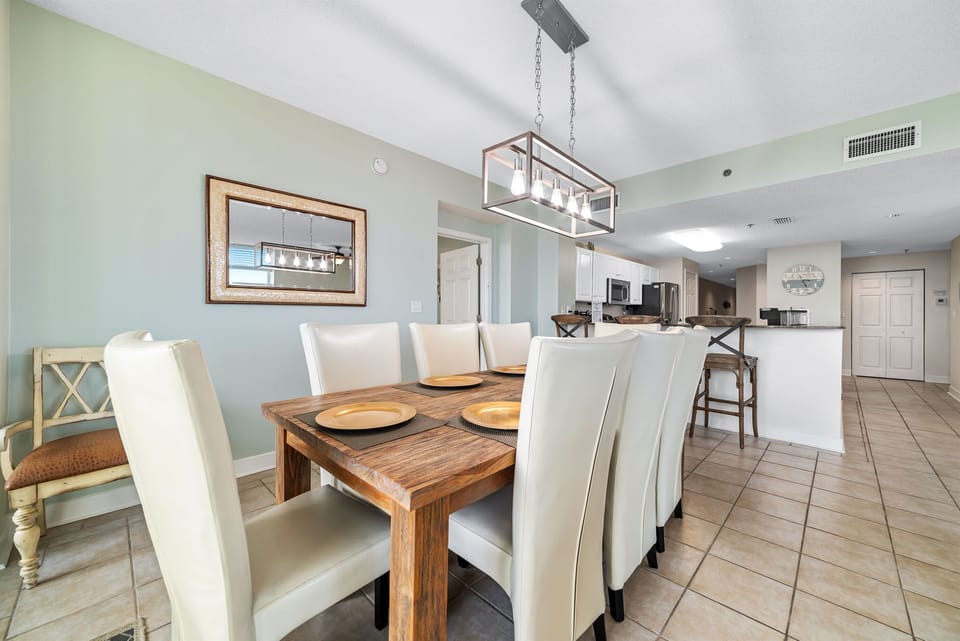Enjoy effortless entertaining in this open-concept living and dining area, showcasing a modern chandelier, plush seating, and stunning natural light.