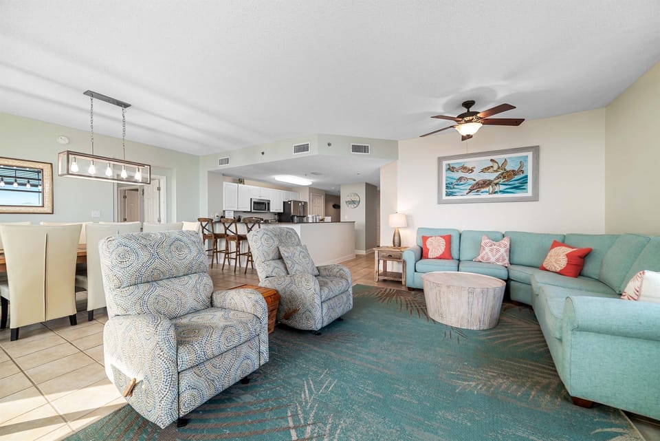 Step into a serene living space featuring a unique starfish-adorned console, plush seating, and expansive sliding doors leading to a scenic balcony.