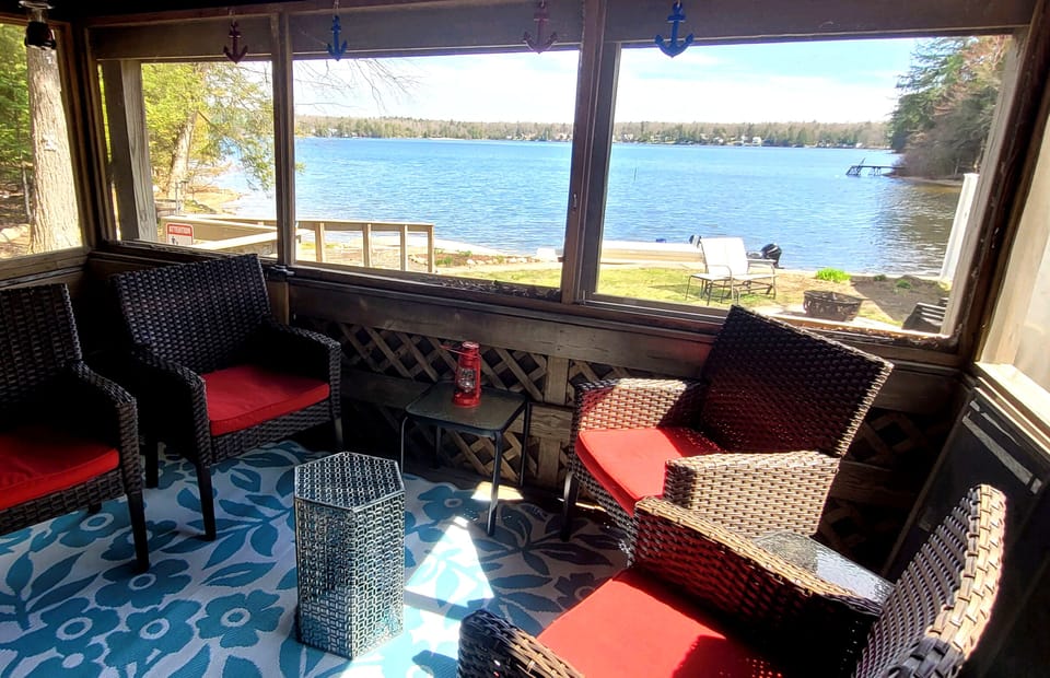 Screen porch overlooking yard and East Caroga Lake