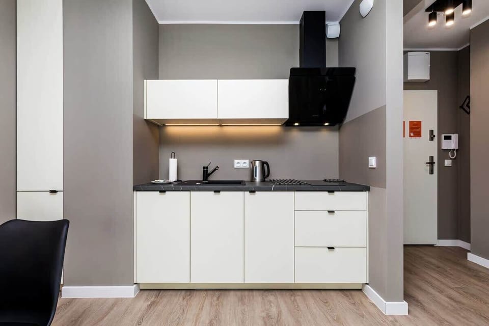 A modern kitchen with a sleek countertop and soft under-cabinet lighting.