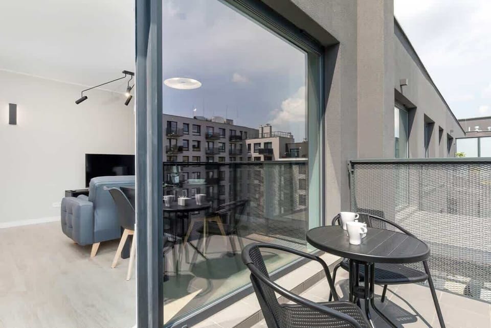 The furnished balcony offers a perfect spot for morning coffee with a view.