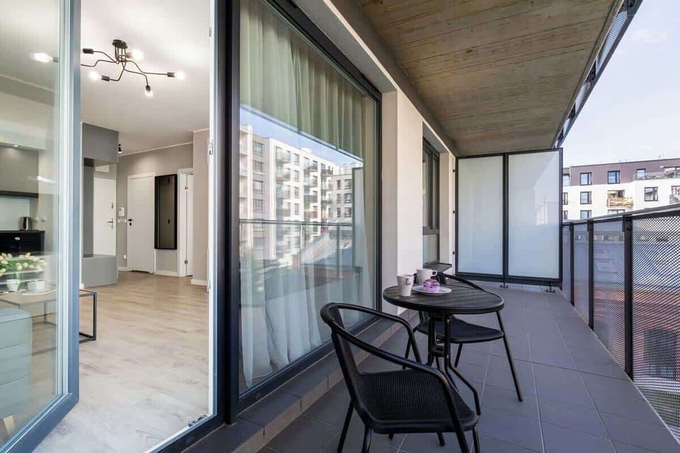 Furnished balcony with green surroundings. 