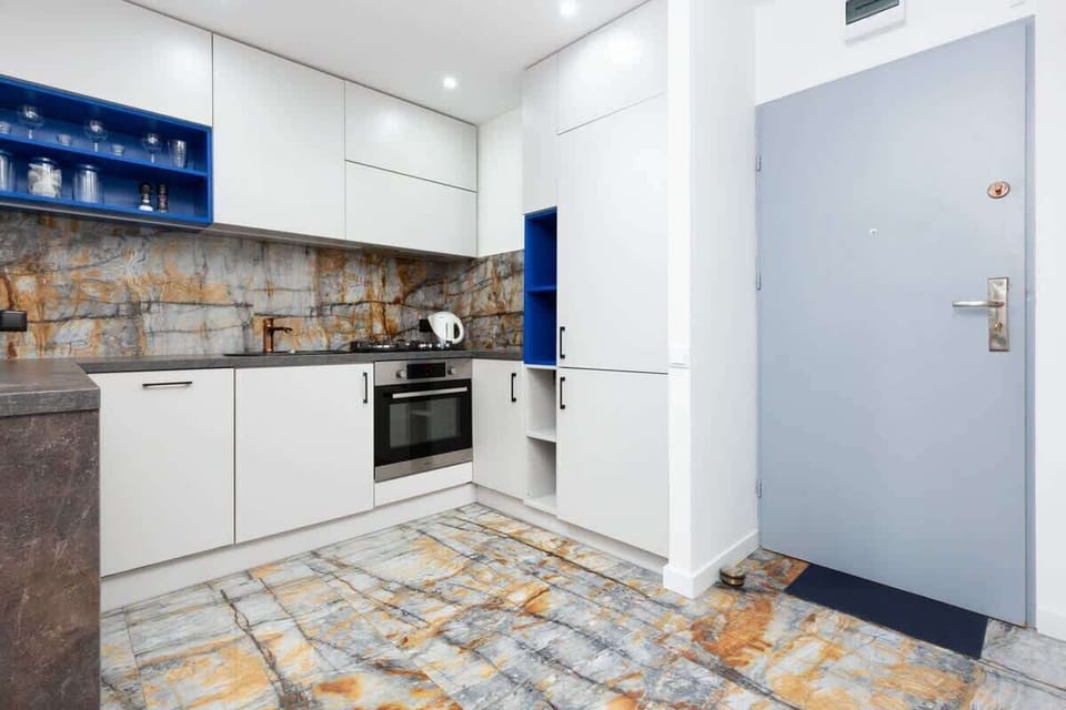 Kitchenette with plenty of kitchen utensils and dishes.