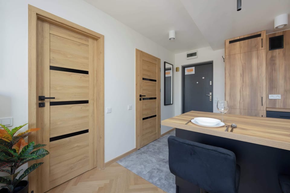 Entrance hall with built-in storage and kitchen view.