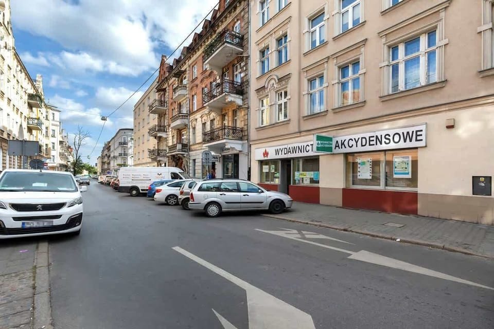 A bustling urban street lined with cars and buildings, capturing the neighborhood's vibe.